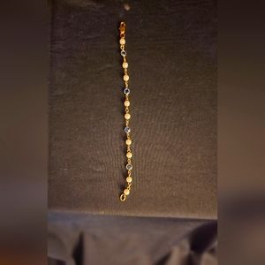 Pearl and blue stone set in gold bracelet